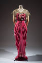 Dark pink floor length evening dress with gold metallic short sleeves, pink flowers on center b…