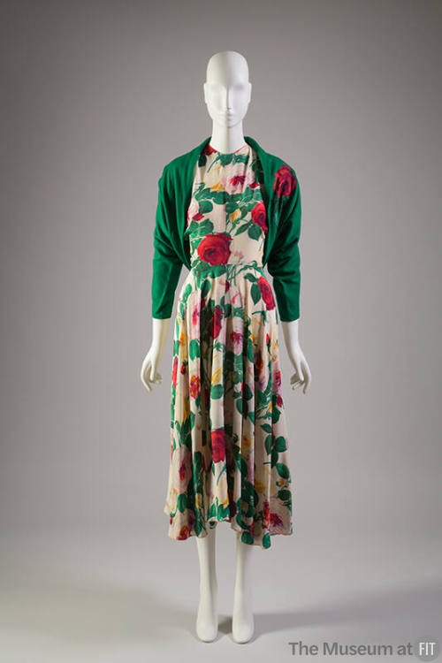 Ivory dress with red, yellow, orange, purple, pink, green floral print, below-the-knee length c…