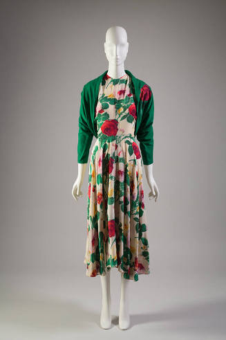 Ivory dress with red, yellow, orange, purple, pink, green floral print, below-the-knee length c…