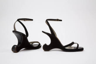 Pair of black ankle strap sandals and high sculptured wedge heels