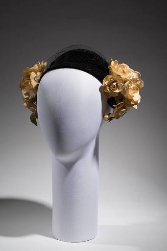Black calot hat with bunches of artificial white gardenias and black sheer nose veil