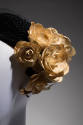 Close up of artificial white gardenias and black sheer nose veil on black hat