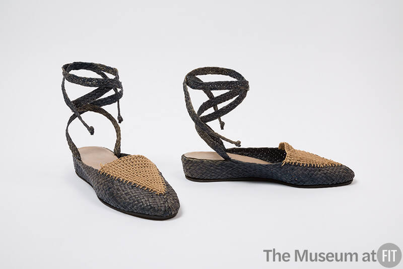 Front and side view of grey and tan closed-toe raffia sandals with wrapped ankle straps