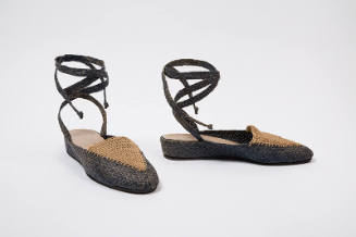 Front and side view of grey and tan closed-toe raffia sandals with wrapped ankle straps