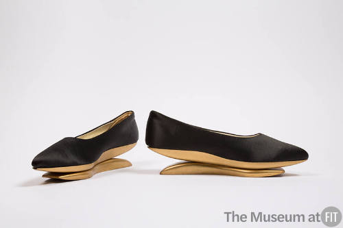 Pair of black pumps with gold painted wood platform rocker sole