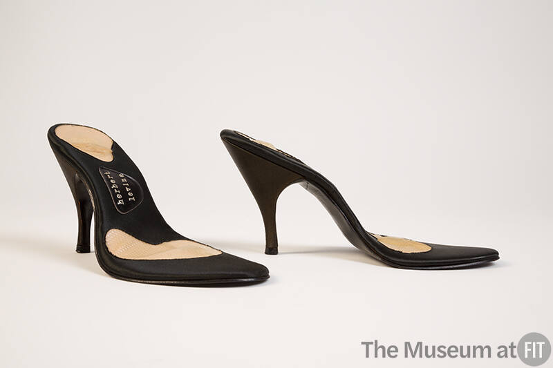 Pair of black high heel shoe soles with no tops and Herbert Levine logo visable on sole