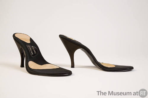 Pair of black high heel shoe soles with no tops and Herbert Levine logo visable on sole