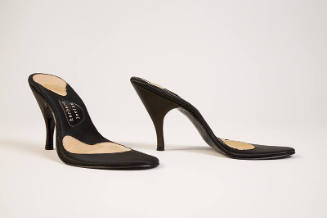 Pair of black high heel shoe soles with no tops and Herbert Levine logo visable on sole