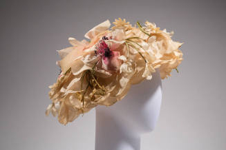 Large hat of light pink rose petals covered in flowers