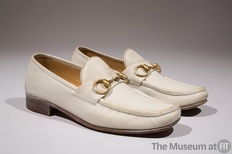 Man's white leather loafers with metal horsebit