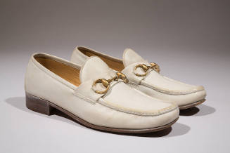 Man's white leather loafers with metal horsebit