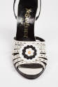 White leather sandals with black and white leather rose on front straps