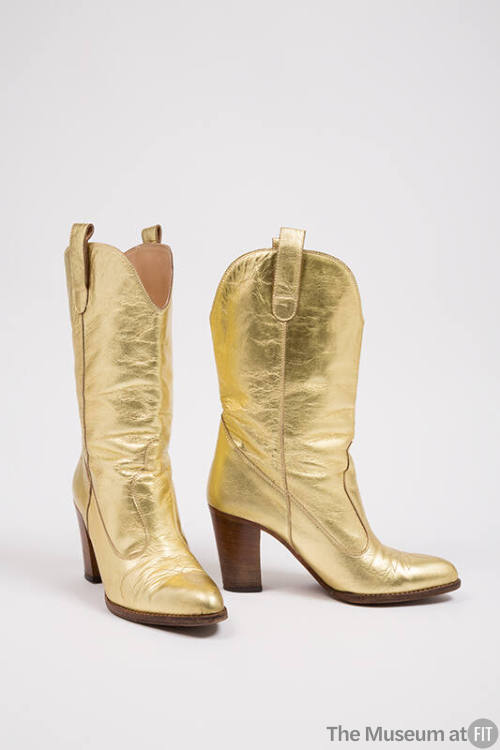 Pair of gold cowboy boots with high wooden heel