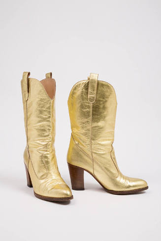 Pair of gold cowboy boots with high wooden heel