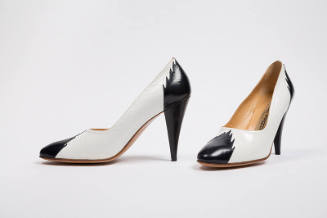 White pumps with black toe cap and high heel with flame edging 