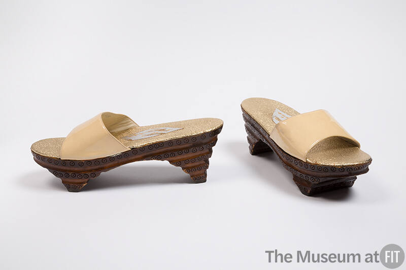 Open toe slide sandals with brown carved stacked wood base and off-white patent leather strap 