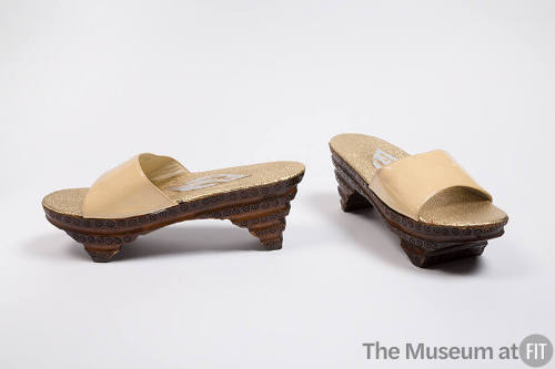 Open toe slide sandals with brown carved stacked wood base and off-white patent leather strap 