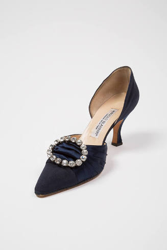 Blue silk high heel pump with cutout sides and large oval rhinestone ornament 