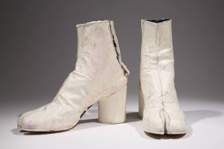 Pair of white painted ankle height boots with high cylindrical heel and split toe