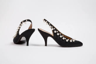 Pair of black slingback shoes with white pearls along topline and high heel