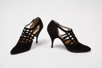 Pair of black suede T-strap cage style pumps with pointed toe and high stiletto heel