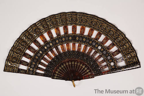 Black fan with tortoise shell sticks and all over silver and gold sequins