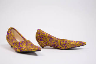 Pair of purple pumps with abstract gold brocade, fabric draped over heel and elongated poined t…