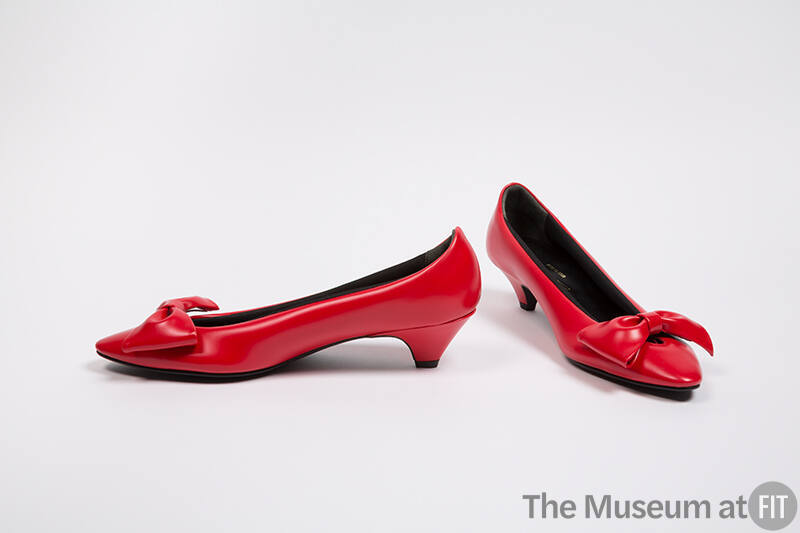 Pair of padded red pumps with large self bow at vamp, medium heel and pointed toe
