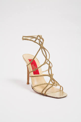 Gold stiletto heel gladiator sandal made of interlacing chains to ankle strap and red Valentino…