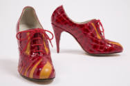 Side and front view of Side red patent leather alligator embossed print high heel lace front sh…