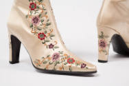 Detail of pointed toe of high heel boots with floral embroidery