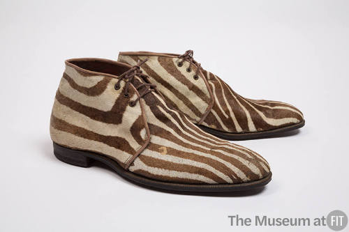 Pair of man’s brown and white zebra print shoes with triple eyelet lace closure