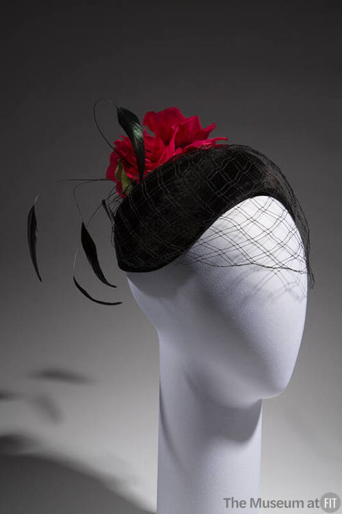 Black velvet curved skull cap with black face veil, long black feathers at back and large red r…