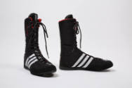 Black lace-up above-the-ankle boxing shoes with three white stripes on sides, red trim 