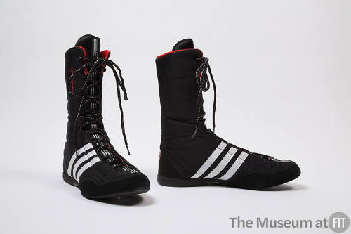 Black lace-up above-the-ankle boxing shoes with three white stripes on sides, red trim 