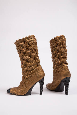 Bronze metallic mid calf high heel boots with overall puckered quilt stitch and black toe cap, …
