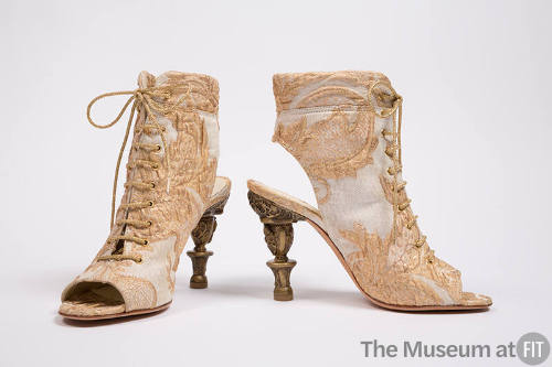 Ivory and metallic gold open toe lace up ankle boots in silk brocade with a large leaf design; …