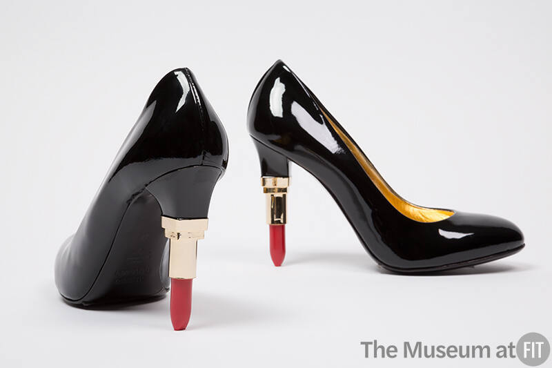 Black pumps with half open replica red lipstick in gold case stiletto heel