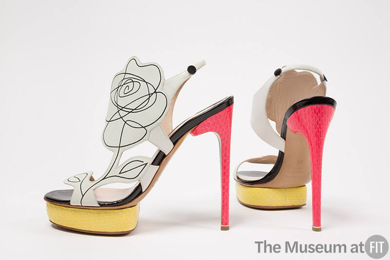 multi color high heel shoes: white upper with black scribble line drawing off a flower, yellow …