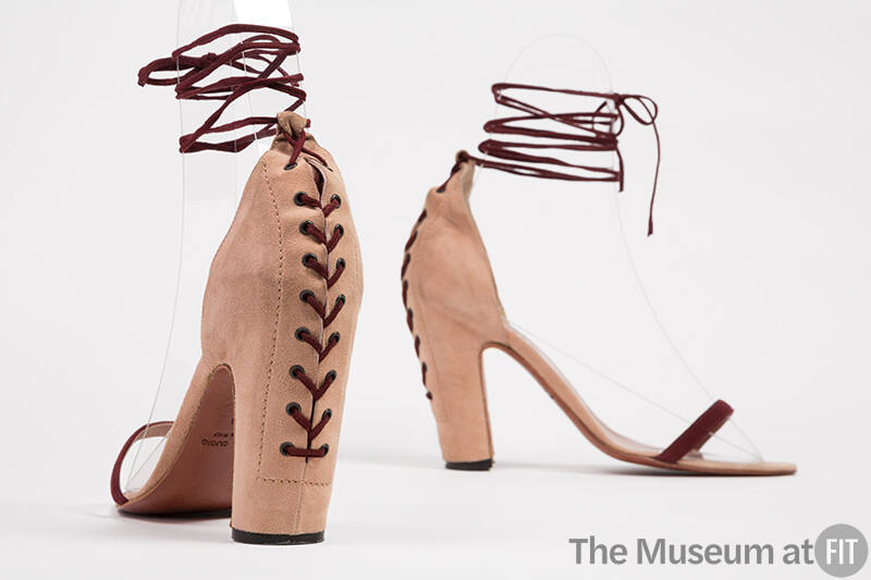 Dusty pink high heel sandals with dark red front bar strap and corset lacing at center back and…