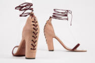 Dusty pink high heel sandals with dark red front bar strap and corset lacing at center back and…