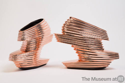 Rose gold multi-level platform ankle boot style shoe with horizontal ribbed mirrored surface te…