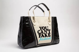 Dark beige tote bag with black sides and black appliqued letters "YOU CAN'T FAKE FASHION" 