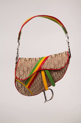 Tan asymmetrically shaped handbag with brown Dior monogram print, green, yellow and red accent …