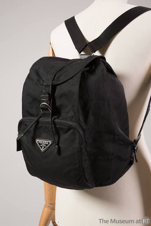 Black backpack with front zipper pocket and Prada logo plate 