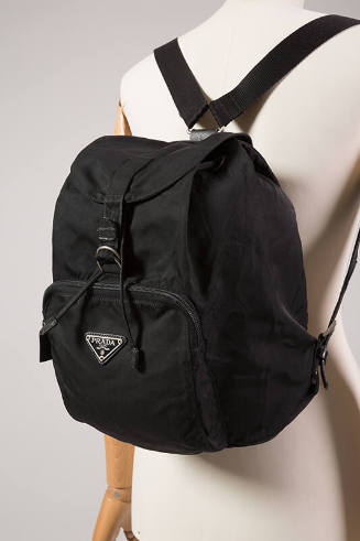 Black backpack with front zipper pocket and Prada logo plate 