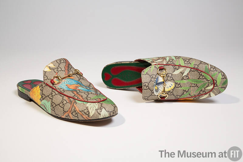 Pair of brown mule slippers with Gucci “GG” logo print and motifs of leaves, flowers and birds …