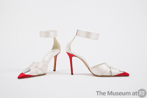 Pair of white evening sandals with wide ankle strap, high red heels and closed pointed red and …