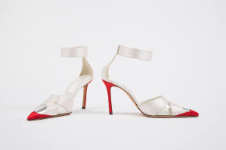 Pair of white evening sandals with wide ankle strap, high red heels and closed pointed red and …