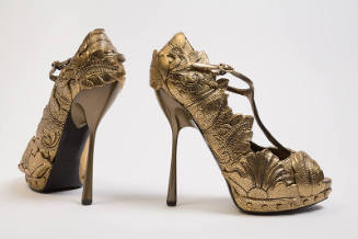 Pair of gold open toe T-strap sandals with high stiletto heel and allover appliqued leaf design